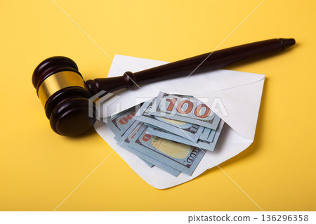 Gavel, money in envelope revealing bribery and corruption Gavel, money in envelope revealing bribery and corruption 136296358