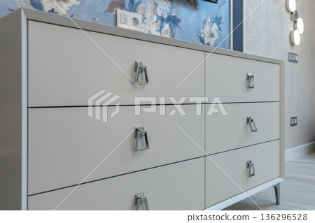 Modern White Dresser with Chrome Hardware in Bedroom 136296528