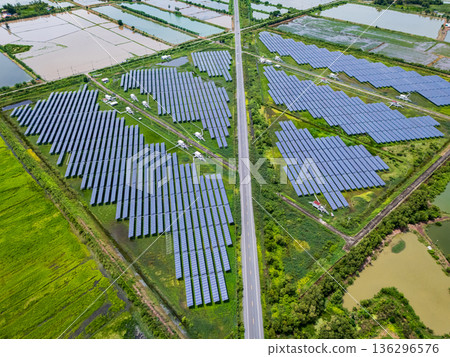 Aerial view drone shot scenic landscape of a road passing through a solar farm in Thailand 136296576