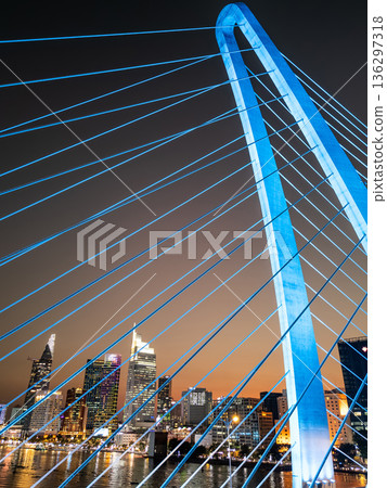 modern cable-stayed suspension bridge over Saigon river with illumination lights, financial downtown district on background, Ho Chi Minh city, Vietnam aerial drone view modern cable-stayed suspension bridge over Saigon river with illumination lights, financial downtown district on background, Ho Chi Minh city, Vietnam aerial drone view 136297318