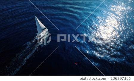 Sailboat cruising open ocean at sunset Sailboat cruising open ocean at sunset 136297395