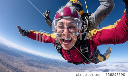 Woman skydiving with instructor over mountainous terrain Woman skydiving with instructor over mountainous terrain 136297398