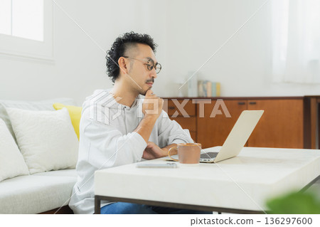 A man who operates a personal computer A man who operates a personal computer 136297600