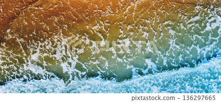 Ocean surf. Waves roll onto the shore. View from above. Nature abstract background. Horizontal banner 136297665