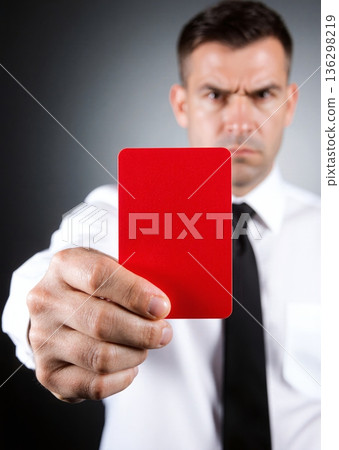 Man shows bright red card with stern expression - ai generated 136298219