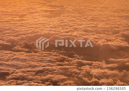 Clouds covering the sky during sunset. The warm colors mix as the light dims, highlighting the textures and shapes of the clouds. The view captures the transition of day to night. High quality photo Clouds covering the sky during sunset. The warm colors mix as the light dims, highlighting the textures and shapes of the clouds. The view captures the transition of day to night. High quality photo 136298385