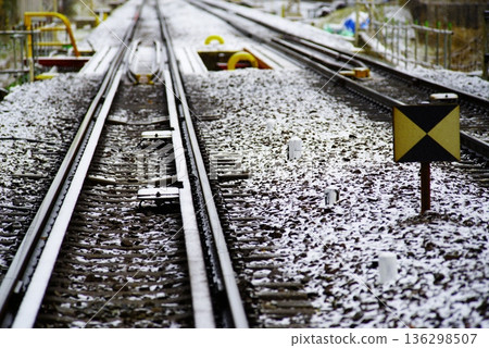 A railway track running through a lightly snow-covered city A railway track running through a lightly snow-covered city 136298507