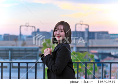 站在屋頂上的年輕女子 136298645