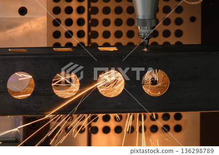 Close Up Fiber Laser Cutting and Engraving Square Tube Parts with Sparks in Industrial Manufacturing Close Up Fiber Laser Cutting and Engraving Square Tube Parts with Sparks in Industrial Manufacturing 136298789