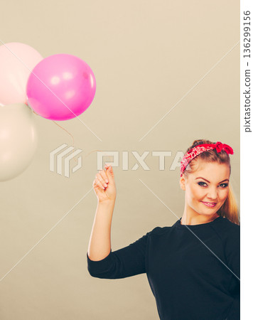 Smiling girl having fun with balloons. Smiling girl having fun with balloons. 136299156