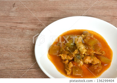 spicy fried winter melon and slice pork in yellow curry sauce on plate spicy fried winter melon and slice pork in yellow curry sauce on plate 136299404