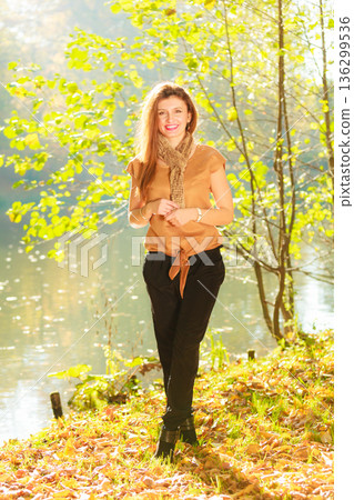 Girl taking walk near river Girl taking walk near river 136299536