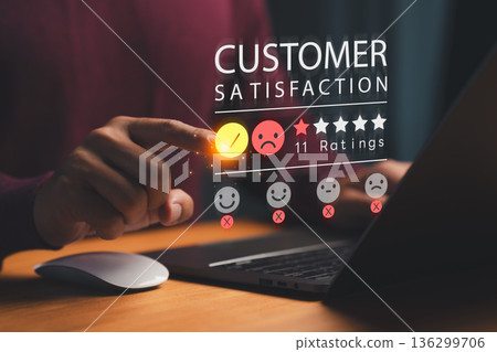 Person using a laptop and selecting a sad emoji in a digital customer satisfaction rating interface, symbolizing feedback, service quality, user experience, and online review analytics. Person using a laptop and selecting a sad emoji in a digital customer satisfaction rating interface, symbolizing feedback, service quality, user experience, and online review analytics. 136299706