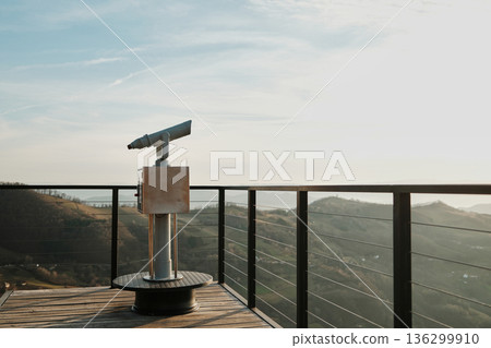 Observation telescope on a viewing platform overlooking rolling hills and valleys in Tara National Park Serbia. Concept of sightseeing travel discovery nature tourism and exploration 136299910