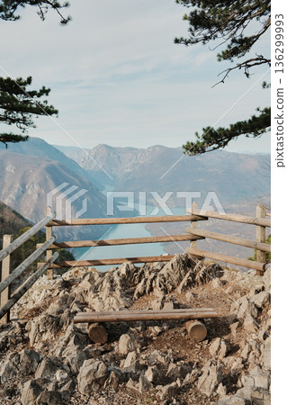 View from Banjska Stena viewpoint overlooking Drina River canyon and Perucac Lake in Tara National Park, Serbia. Rocky lookout with wooden fence above mountain landscape View from Banjska Stena viewpoint overlooking Drina River canyon and Perucac Lake in Tara National Park, Serbia. Rocky lookout with wooden fence above mountain landscape 136299993