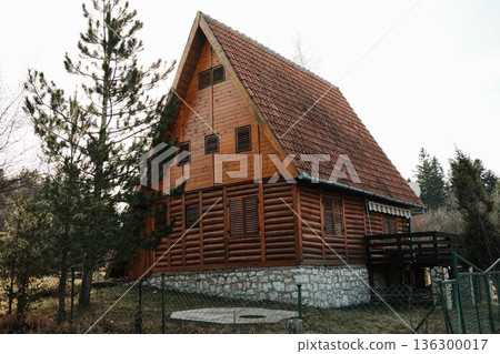 Traditional wooden log cabin located near dense forest in Tara National Park, Serbia. Example of mountain countryside housing and rural architecture Traditional wooden log cabin located near dense forest in Tara National Park, Serbia. Example of mountain countryside housing and rural architecture 136300017