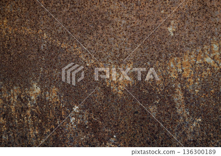 An old surface of rusty metal sheet roof textured. Rust is an iron oxide formed by the reaction of iron and oxygen in the catalytic presence of water or air moisture. An old surface of rusty metal sheet roof textured. Rust is an iron oxide formed by the reaction of iron and oxygen in the catalytic presence of water or air moisture. 136300189