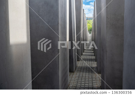 Berlin, germany, august 12, 2023. Concrete stelae form narrow passages at the memorial to the murdered jews of europe, symbolizing a disorienting labyrinth 136300356