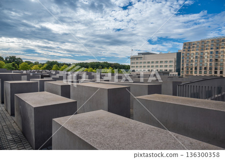 Berlin, germany, august 12, 2023. Memorial to the murdered jews of europe in berlin: geometric field of concrete stelae forming a solemn, contemplative urban maze Berlin, germany, august 12, 2023. Memorial to the murdered jews of europe in berlin: geometric field of concrete stelae forming a solemn, contemplative urban maze 136300358