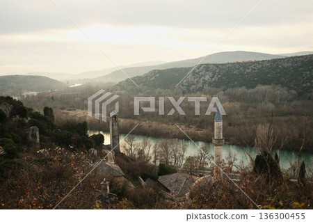 Panoramic view of Pocitelj village and fortress overlooking the Neretva River in Bosnia and Herzegovina. Stone houses and hills form a timeless cultural travel concept Panoramic view of Pocitelj village and fortress overlooking the Neretva River in Bosnia and Herzegovina. Stone houses and hills form a timeless cultural travel concept 136300455