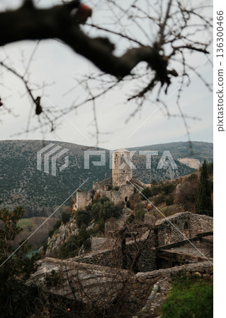 Medieval stone tower of Pocitelj Fortress standing above the Neretva River valley in Bosnia and Herzegovina. Historic architecture and dramatic landscape create a calm travel and heritage concept 136300466
