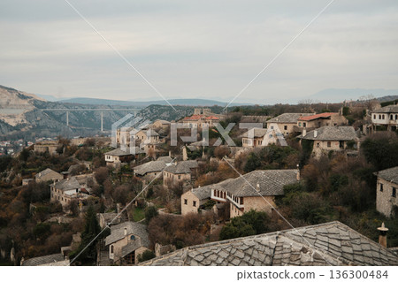 Traditional stone houses of Pocitelj village spread across a steep hillside with historic architecture and rugged terrain in Bosnia and Herzegovina Traditional stone houses of Pocitelj village spread across a steep hillside with historic architecture and rugged terrain in Bosnia and Herzegovina 136300484