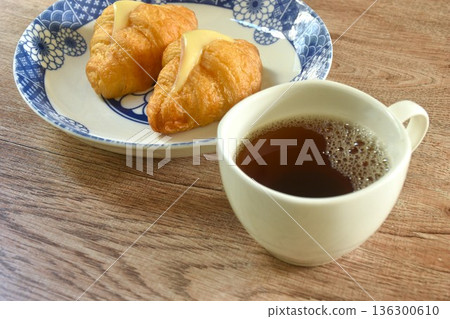 baking crispy butter croissant French bread stuffed ham cheese on plate eat with black hot coffee cup baking crispy butter croissant French bread stuffed ham cheese on plate eat with black hot coffee cup 136300610