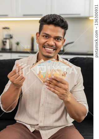 Indian man counts euro cash happy makes money gesture plans dream purchase savings bonus invest plan Indian man counts euro cash happy makes money gesture plans dream purchase savings bonus invest plan 136300931