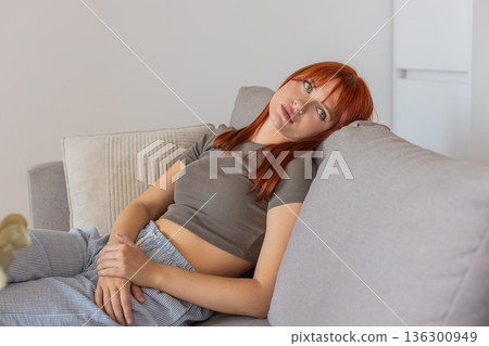 Young woman feels drained in bad mood after harsh news so low energy stare deep sigh and slow slump Young woman feels drained in bad mood after harsh news so low energy stare deep sigh and slow slump 136300949