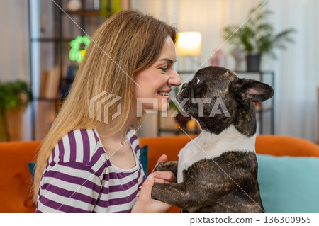 Middle-aged woman with dog close face portrait smiles nose to nose tender moment love and joy detail Middle-aged woman with dog close face portrait smiles nose to nose tender moment love and joy detail 136300955