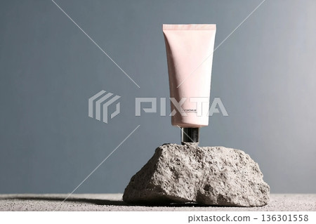 Pink cosmetic tube at natural rock podium at grey background , visuals for beauty and cosmetic product . 136301558