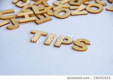 Tips text formed with wooden letters on white background representing advice guidance and helpful information concept. 136301618