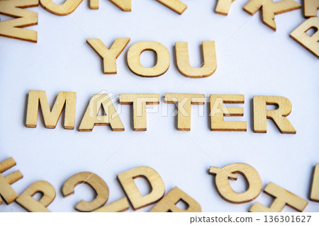 You matter text composed of wooden letters on white background representing motivation self worth encouragement and mental wellness concept. 136301627