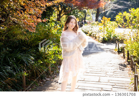 Woman relaxing in autumn park Woman relaxing in autumn park 136301708