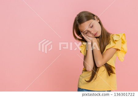 Child girl kid feeling tired gently lays head on hands and peacefully falls asleep exhausted emotion Child girl kid feeling tired gently lays head on hands and peacefully falls asleep exhausted emotion 136301722