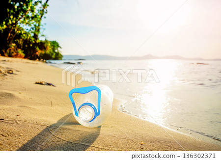 Plastic bottle waste on beach. Ocean pollution. Marine litter. Garbage plastic bottle on sand beach Plastic bottle waste on beach. Ocean pollution. Marine litter. Garbage plastic bottle on sand beach 136302371