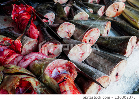 Fish sale at local market. Fresh seafood in ice on counter in grocery store. Fish sale at local market. Fresh seafood in ice on counter in grocery store. 136302373