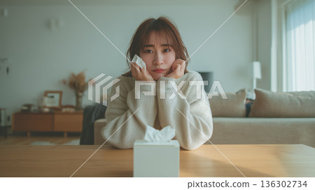 /* Image of poor health in spring, with hay fever and tissues in hand */ 136302734