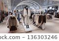 Modern clothing store interior with winter collection on mannequins. 136303246