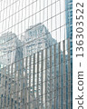 Reflection of old skyscrapers on a glass wall. New York City. 136303522