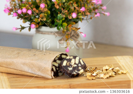 Chocolate salami sausage on wooden board 136303616