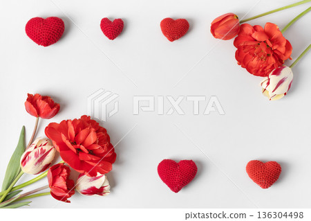Women's day banner. Valentine's day and 8 march holiday background with red tulips and knitted hearts. Background for website, poster, brochures, promotional materials Women's day banner. Valentine's day and 8 march holiday background with red tulips and knitted hearts. Background for website, poster, brochures, promotional materials 136304498