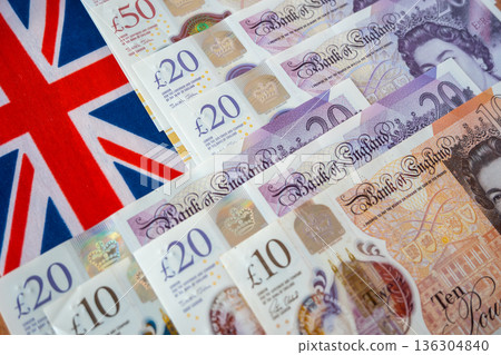England national flag and british pound money. United Kindom paper bills for commerce concept. England national flag and british pound money. United Kindom paper bills for commerce concept. 136304840