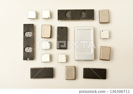 Old chips on a white background. Electronic components. Processors in metal and plastic cases. Old chips on a white background. Electronic components. Processors in metal and plastic cases. 136306711