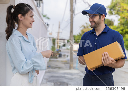 Delivery express courier young man use giving boxes or Food to woman customer  at front home.  136307496
