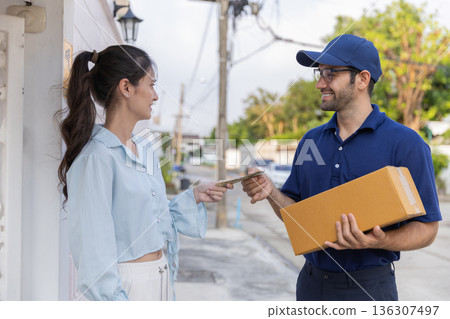 Delivery express courier young man use giving boxes or Food to woman customer  at front home.  136307497