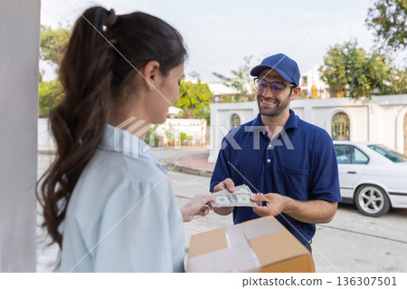 Delivery express courier young man use giving boxes or Food to woman customer  at front home.  136307501