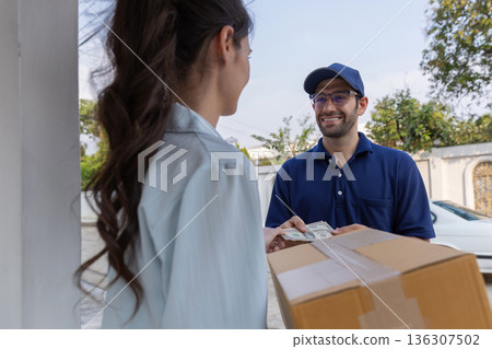 Delivery express courier young man use giving boxes or Food to woman customer  at front home.  136307502