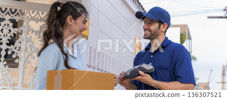 Delivery express courier young man use giving boxes or Food to woman customer at front home. Delivery express courier young man use giving boxes or Food to woman customer at front home. 136307521