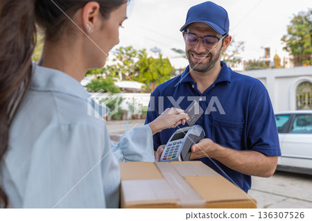 Delivery express courier young man use giving boxes or Food to woman customer at front home. Delivery express courier young man use giving boxes or Food to woman customer at front home. 136307526